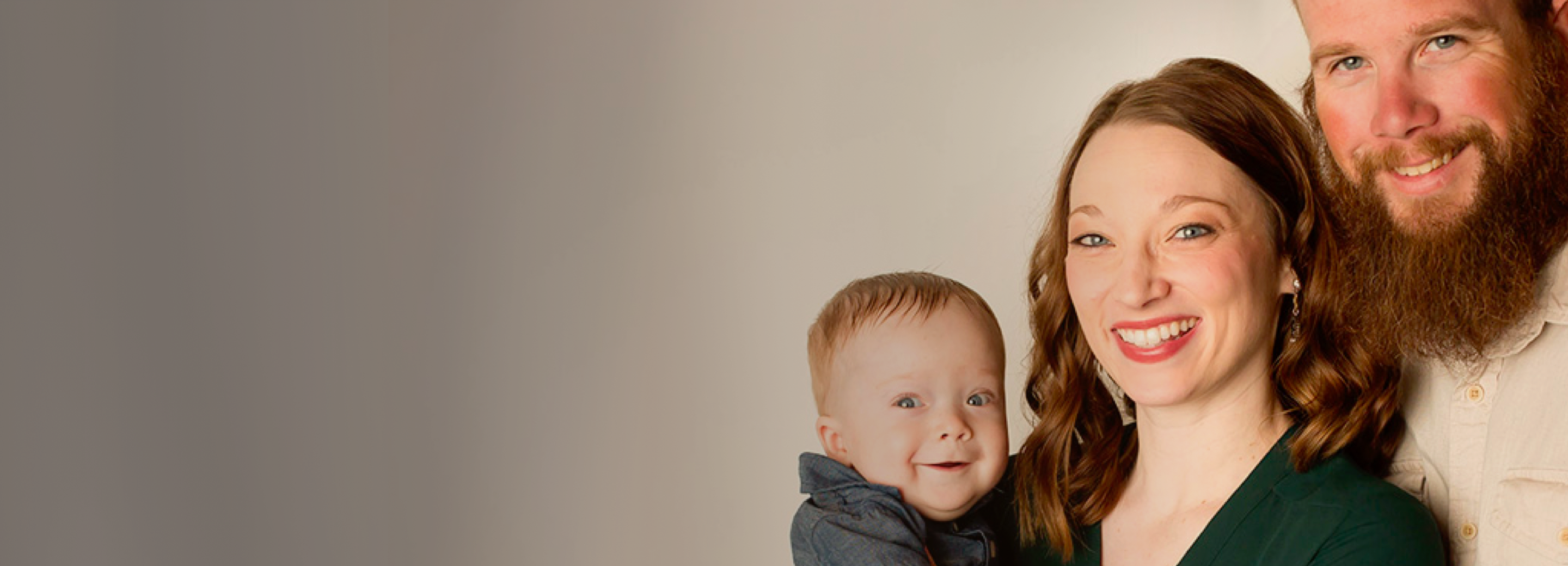 An RMHC family, the Kerres, smile for the camera, right to left, Adam and Johnna holding their infant son Everett