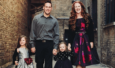 The Ledvinas, an RMHC family, posed holding hands in a picturesque brick-lined alley