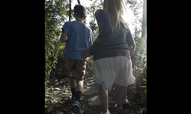 Children running through foliage